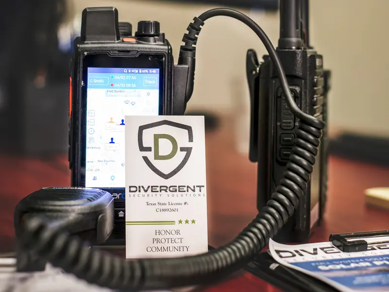 PoC radios on a security operations desk with a dispatch screen