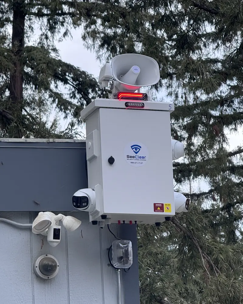 See Clear active deterrent security unit with camera, speaker and strobe light mounted on a building